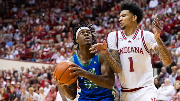 Nov 7, 2023; Bloomington, Indiana, USA; Florida Gulf Coast Eagles forward Keeshawn Kellman (32) drives against Indiana Hoosiers center Kel'el Ware (1) in the second half at Simon Skjodt Assembly Hall. Mandatory Credit: Trevor Ruszkowski-USA TODAY Sports